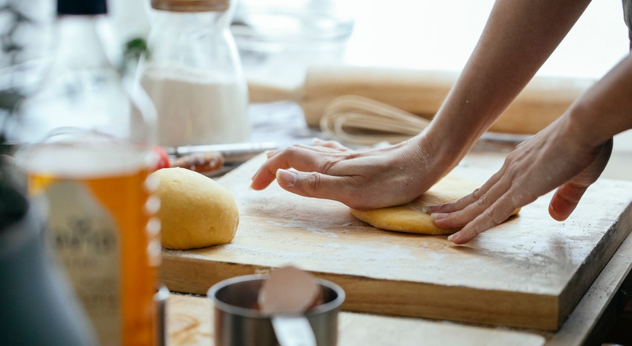 The Art of Drawing Readers In: Your attractive post title goes here Female hands kneading fresh dough on wooden chopping board with flour in kitchen